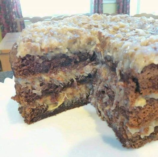 The BEST homemade German Chocolate Cake with layers of coconut pecan frosting and chocolate frosting. This cake is incredible!