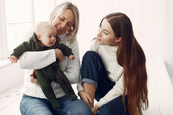 Two woman play with a baby | Source: prostooleh on Freepik