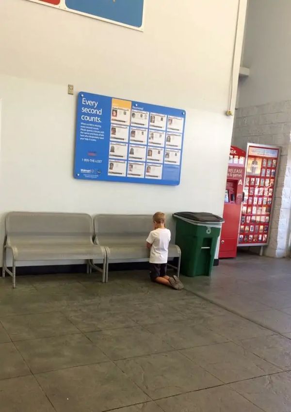 Braydon praying in front of the sign board