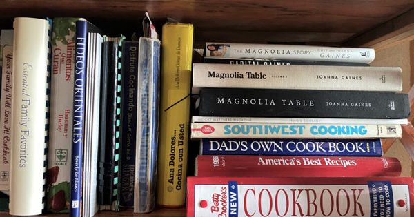 Miami, Fl, USA: March 1, 2021: Kitchen Cookbooks bunched together on shelf. Many different cuisines are shown.