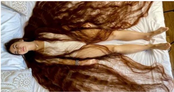 Real life Rapunzel has hair brushing the ground behind her with 90-inches of flowing brown locks.