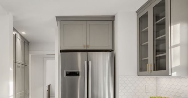 Kitchen Detail in Newly Remodeled Home: Hardwood Floors, Stainless Steel Refrigerator, and Quartz Counters