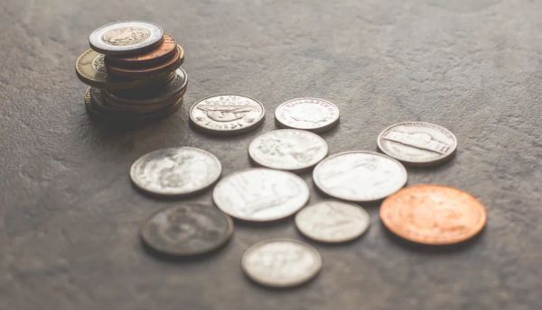 A person holding a jar of coins