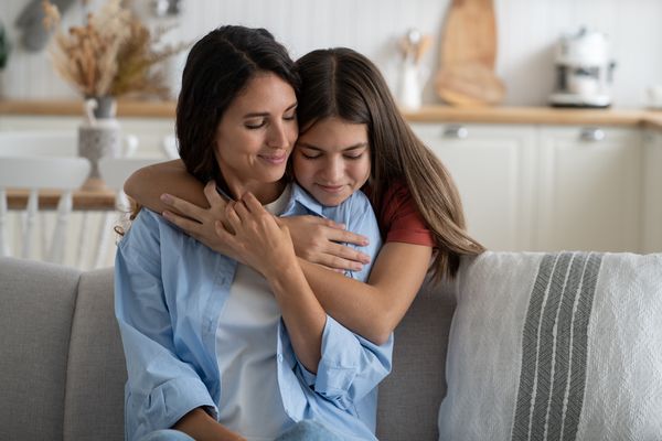 A young girl hugging her mother