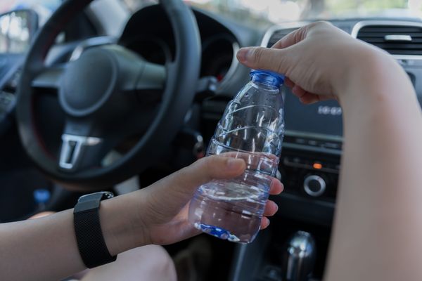 Car with plastic bottle on tire