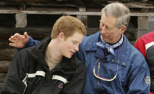 Prince Harry (left) talking with his father, King Charles (right)