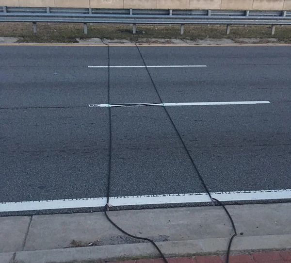 Here’s what those mysterious black cables on the road signify.