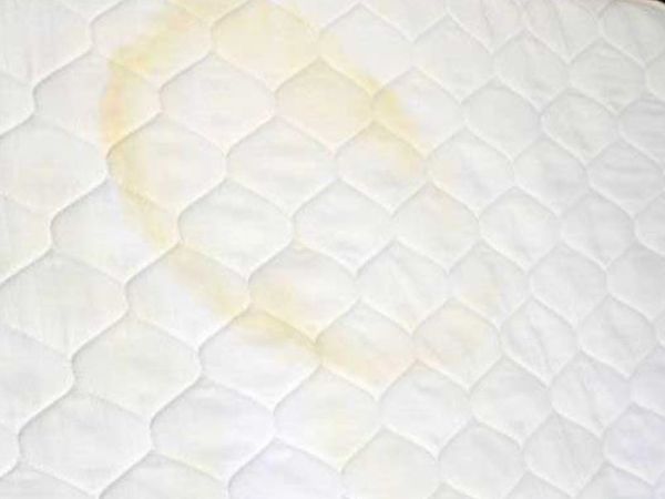 A mattress with stains.