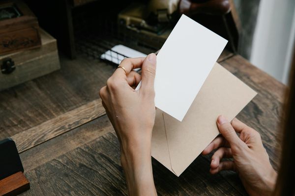 A woman opening an envelope | Source: Pexels